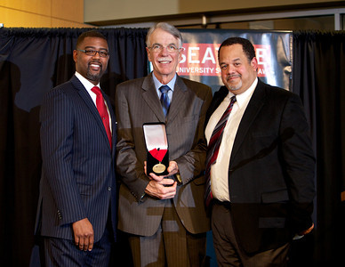 Washington Supreme Court Justice Charles W. Johnson, center, accepts the 2013 Dean's Medal from Seattle University School of Law Alumni President Craig Sims (left) and Seattle University Law School Dean Mark Niles. Photo by Matt Hagen/Seattle University