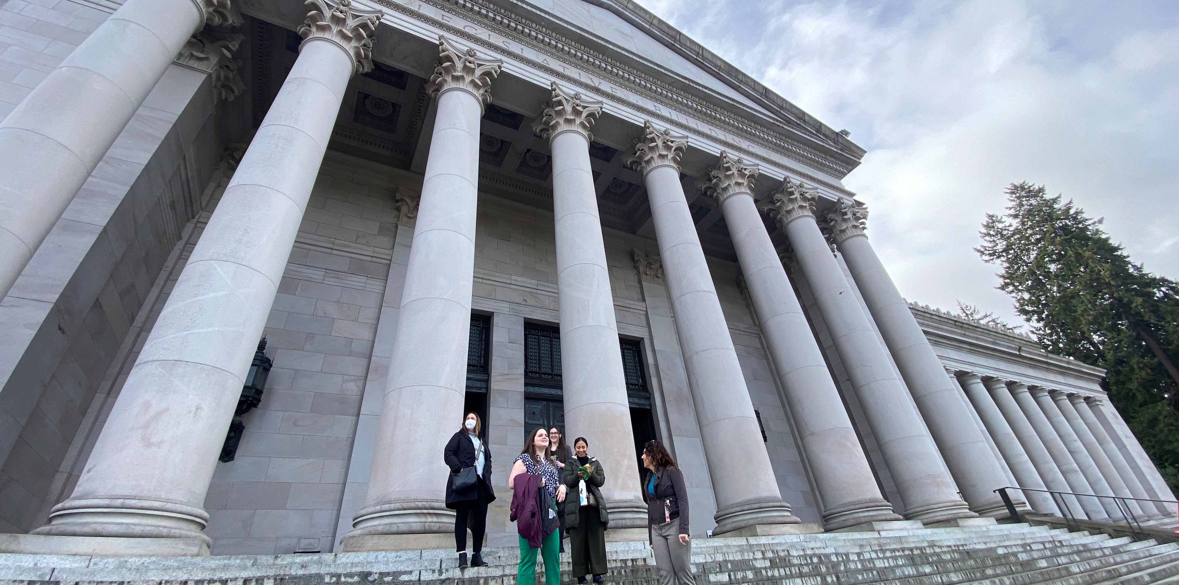 Equity and Access team members standing in front of a judicial building